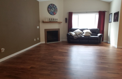 Finished living space with hardwood flooring and fireplace
