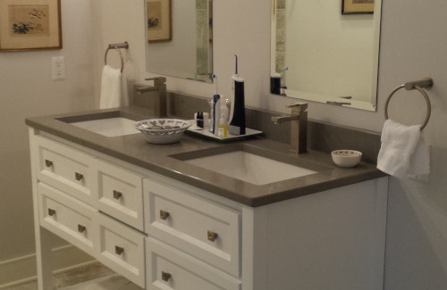 Bathroom remodel with white double vanity and large mirrors