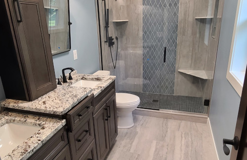 Bathroom remodel with granite vanity and custom tiled walk-in shower