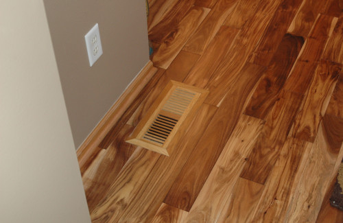 Natural wood flooring installation with floor vent detail