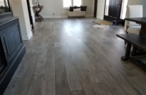 Gray wood-look flooring installed throughout an open living space